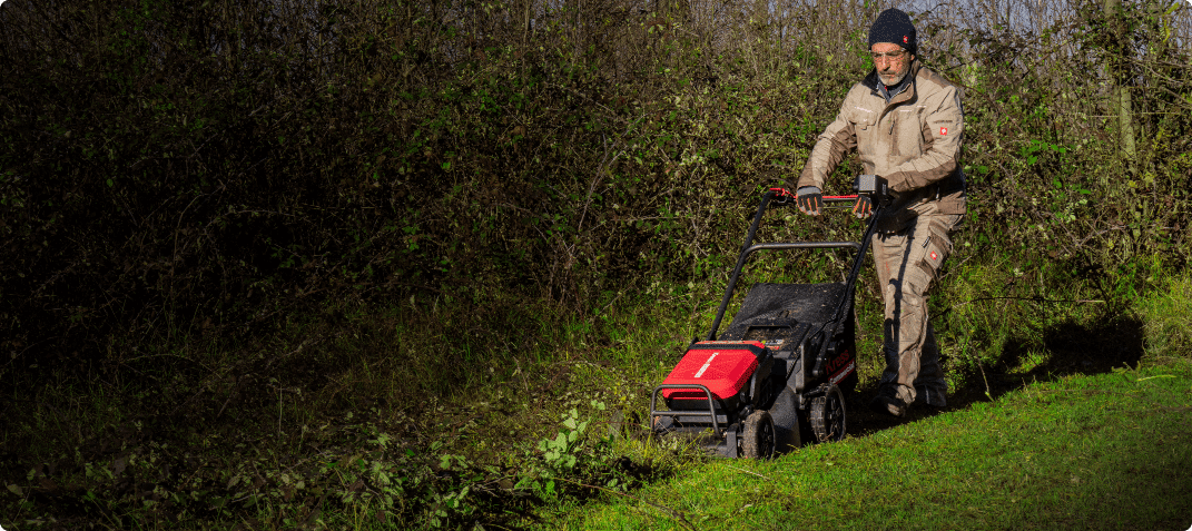 Homme tondant avec une tondeuse Kress
